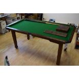 A small oak snooker table with slate bed, two snooker cues,