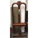 A Victorian hall stand with central oval mirror, seven hat hooks,