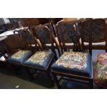 Three George III Chippendale style dining chairs with baluster pierced splats and needlework seats