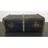 A blue canvas and wooden bound cabin trunk with leather handles bearing some labels 46x76x30cm