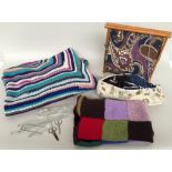 A crochet blanket 153x181cm together with a knitted blanket 98x82cm and a selection of wool,