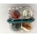 A selection of four semi-precious stone eggs, one in onyx, one in Mexican fire opal and two others,