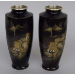 A pair of black Japanese Shakudo baluster vases depicting temples inlaid with gilt metal and silver