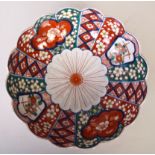 An Imari charger with scalloped edge, of floral design in typical Imari palette.