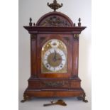 A late Victorian walnut and gilt metal mantel clock,