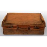 A small brown leather gentleman's vanity case with canvas travel cover,