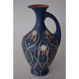 A Mettlach coal painted terracotta vase decorated with irises, 23cmH,