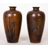 A pair of matching Japanese bronze vases depicting cranes amid rushes, circa 1900,