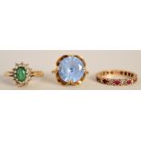 A gold and aquamarine dress ring, a gold ruby and white sapphire eternity ring,