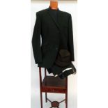 A 1960s worsted wool tailored suit in a deep olive green and with green lining. Labelled H. J.