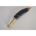 A small brass kukri/khukuri in leather scabbard with brass chape, 15.