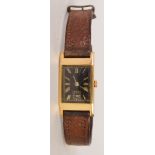 An Art Deco yellow metal gentleman's wrist watch with Swiss swan neck movement and leather strap