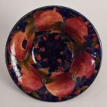 A Moorcroft circular fruit bowl with a flared rim in the 'Pomegranate' pattern, signed in green 'W.