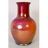 A Pilkingtons Lancastrian baluster vase decorated in a green and orange lustre glaze, serial no.