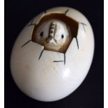 A Japanese netsuke of a chick emerging from an egg from the Meiji period,