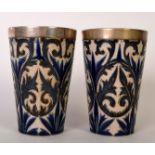 A pair of Royal Doulton stoneware tumblers by Florence Barlow,