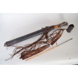 A leather quiver of nine barbed metal headed bamboo arrows,