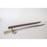 A French chassepot bayonet in scabbard from the Second French Empire featuring worn engraving on