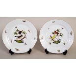 A pair of Herend porcelain plates decorated with birds and foliage and basket work borders,