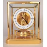 A Jaeger-LeCoultre Atmos clock, with white circular dial,