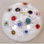 A 20th century paperweight with millefiori rods on a scrambled egg ground, dated '70' 'S',