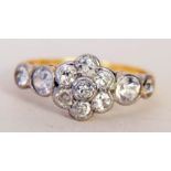 A diamond set cluster ring in 18ct gold band size N