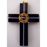 A Victorian banded black agate and yellow metal crucifix of large size with an inset hair panel to