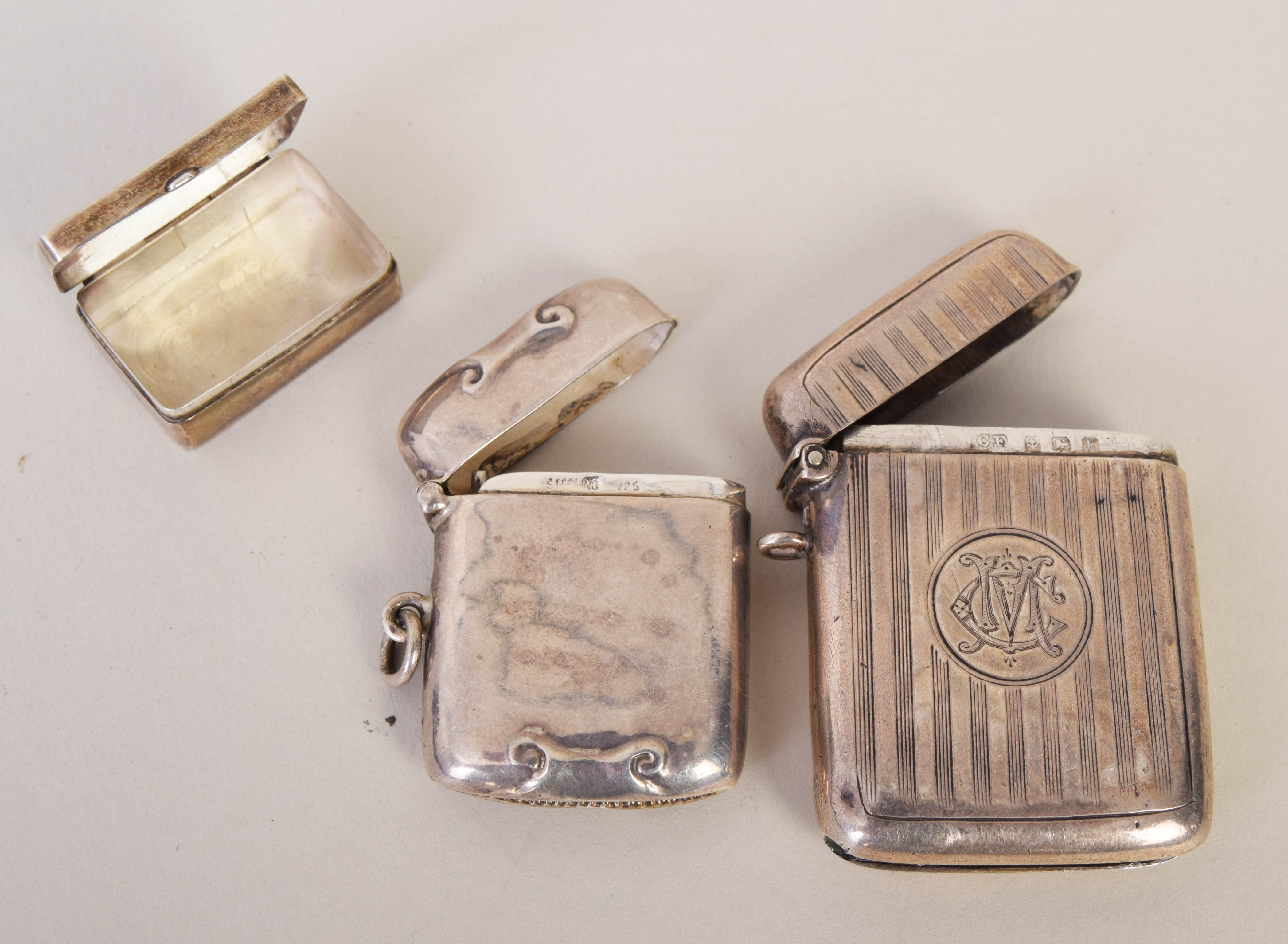 Two silver vesta boxes together with a small silver box