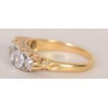 An early 20th century 18ct gold and five stone diamond engagement ring