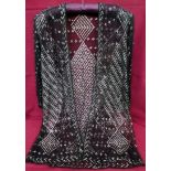 A 1920s/30s black Egyptian Azute jacket geometrically patterned with silver metal throughout.