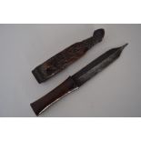 A dagger with carved wooden scabbard and hilt, possibly from the Philippines,
