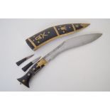 A kukri/khukuri dagger with a bronze and wooden hilt complete with smaller karda blade and chakmak