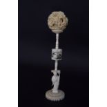 A late 19th century Japanese ivory puzzle ball and stand, 6cmH and 21.