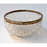 A crystal cut bowl with sterling silver rim. Hallmarked J.