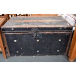 Vintage black travel trunk with wooden bracings and metal handles,