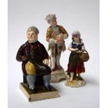 Staffordshire figure of a seated man 14cmH, and two other Continental china figurines,
