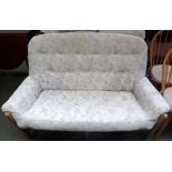 An Ercol two seater sofa with cushioned upholstery,