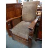 An early 20th century oak open armchair, wicker side panels with robust supports,