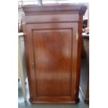 A George III mahogany corner cupboard