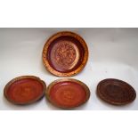 Four oriental wooden plates with a red and gold decoration