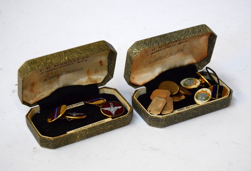 Two pairs of gold plated military cufflinks bearing the crest and colours of The Parachute Regiment