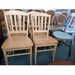 Four light pine kitchen chairs together with two hooped rail back kitchen chairs with removable