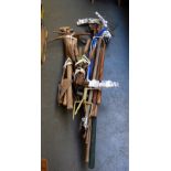 A large quantity of garden tools including pickaxe, rakes,