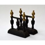 Pair of cast iron fire dogs with brass knobs