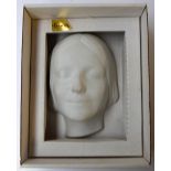 A porcelain mask of a girl's head,