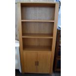 A modern oak bookcase with two shelves and two cupboard doors below 90 x 32 x 140cmH