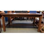 A stained pine kitchen table with square legs