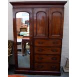 A Victorian mahogany combination wardrobe with drawers below and mirror to the side