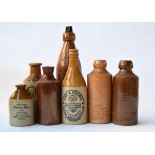A selection of vintage earthenware drinking bottles including 'Home and Colonial Ginger Beer',