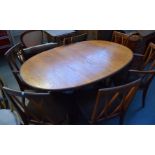 An oval 'G Plan' extending dining room table together with six 'G Plan' dining chairs upholstered